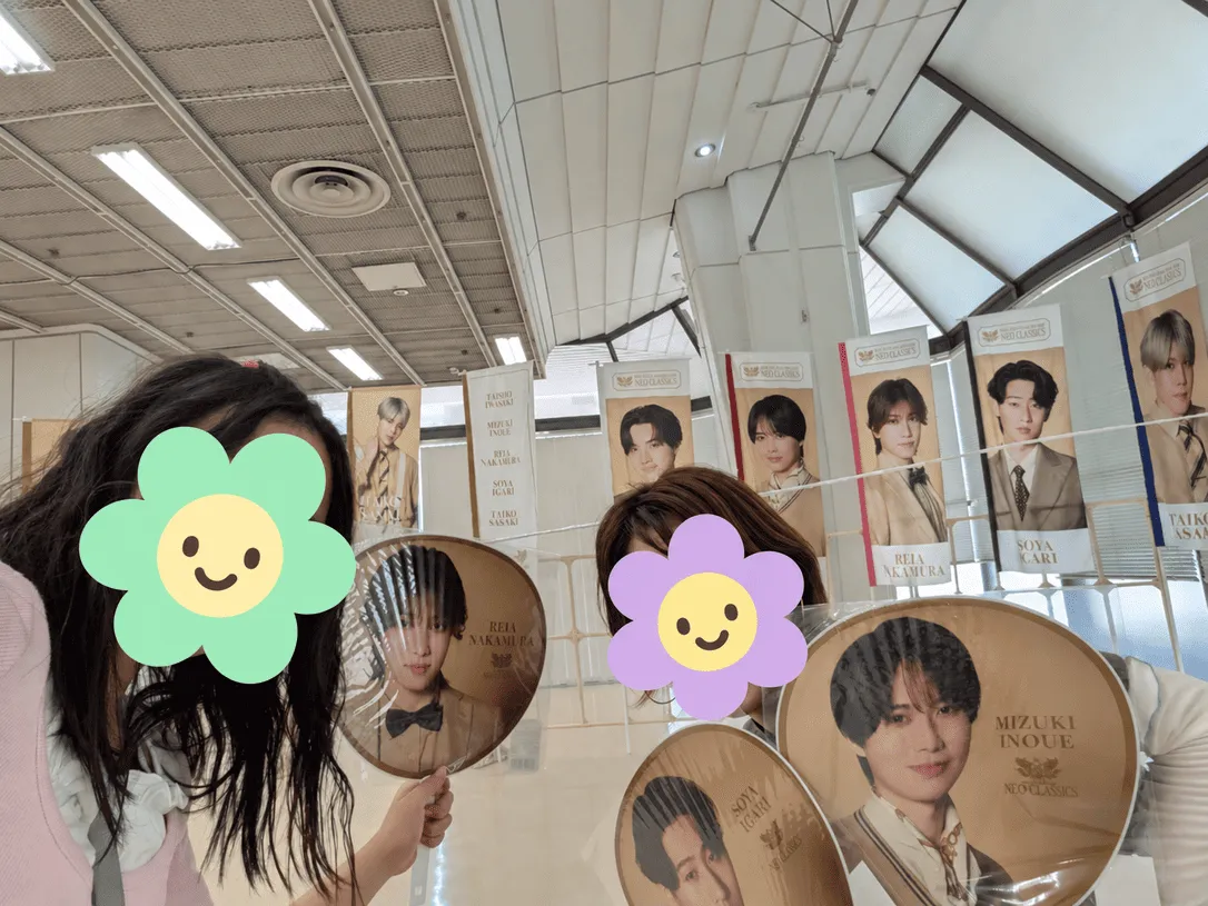 グッズ購入後、フラッグと写真を撮る母娘の写真